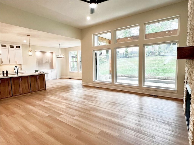 6932 Kenton St, Shawnee, KS 66226 - unfurnished living room with light wood-style flooring and recessed lighting