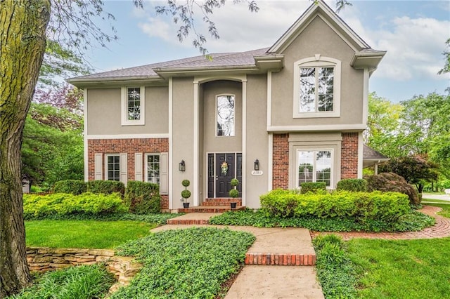2101 Riviera Dr, Lawrence, KS 66047 - view of front of home featuring brick siding, stucco siding, and a front yard