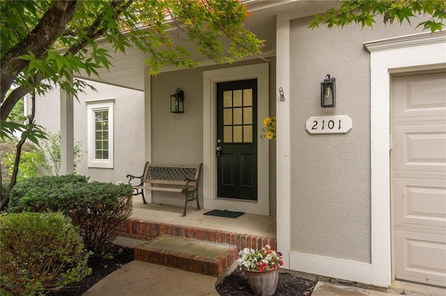 2101 Riviera Dr, Lawrence, KS 66047 - view of exterior entry with a porch and stucco siding