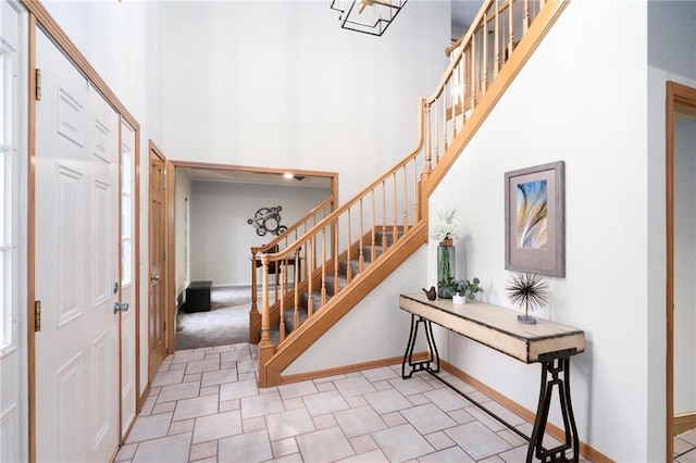 2101 Riviera Dr, Lawrence, KS 66047 - entrance foyer featuring a towering ceiling, stairs, and baseboards