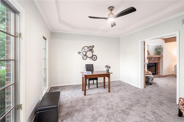 2101 Riviera Dr, Lawrence, KS 66047 - office area featuring carpet, a ceiling fan, a raised ceiling, a brick fireplace, and crown molding