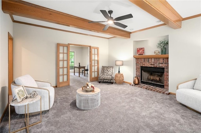 2101 Riviera Dr, Lawrence, KS 66047 - living room with beam ceiling, carpet flooring, french doors, a brick fireplace, and ceiling fan