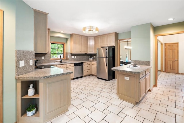 2101 Riviera Dr, Lawrence, KS 66047 - kitchen featuring stainless steel appliances, a peninsula, backsplash, light brown cabinets, and a sink