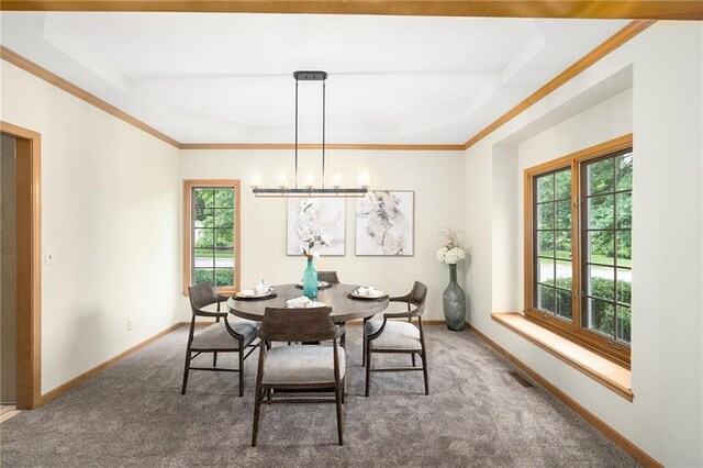 2101 Riviera Dr, Lawrence, KS 66047 - dining area featuring a tray ceiling, carpet floors, baseboards, ornamental molding, and a chandelier