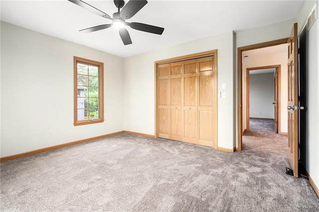 2101 Riviera Dr, Lawrence, KS 66047 - unfurnished bedroom with carpet floors, baseboards, a closet, and a ceiling fan