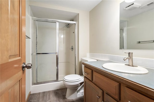2101 Riviera Dr, Lawrence, KS 66047 - bathroom with vanity, wood finished floors, a shower stall, and toilet