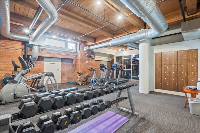 712 Broadway Blvd Unit 607, Kansas City, MO 64105 - exercise room with brick wall, carpet, and wood ceiling
