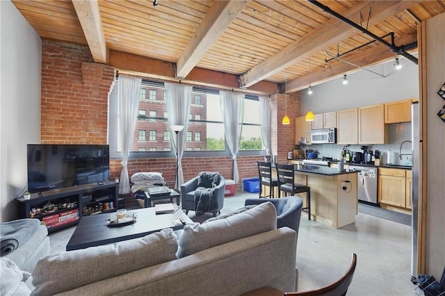 712 Broadway Blvd Unit 607, Kansas City, MO 64105 - living area with wooden ceiling with exposed beams, finished concrete floors, and brick wall