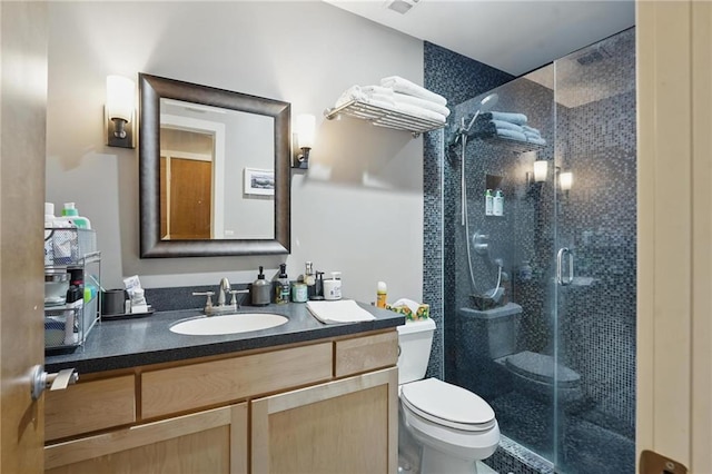 712 Broadway Blvd Unit 607, Kansas City, MO 64105 - bathroom featuring toilet, a stall shower, and vanity