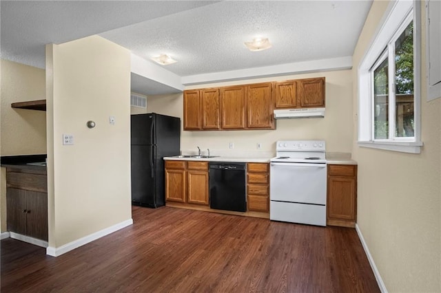 3729 Brush Creek Dr N, Lawrence, KS 66047 - kitchen with black appliances, under cabinet range hood, dark wood-type flooring, light countertops, and brown cabinets