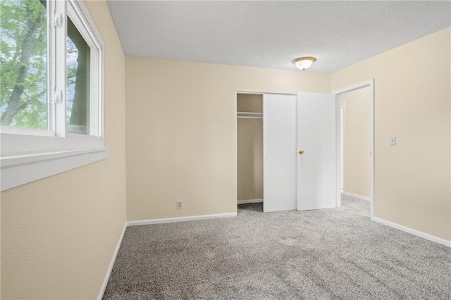 3729 Brush Creek Dr N, Lawrence, KS 66047 - unfurnished bedroom with carpet, a closet, baseboards, and a textured ceiling