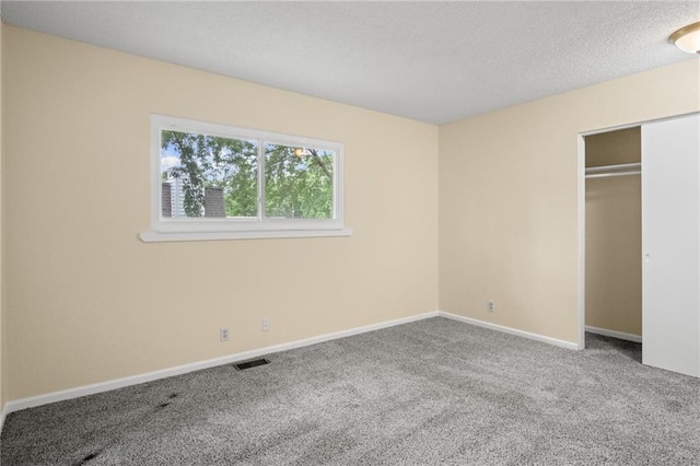 3729 Brush Creek Dr N, Lawrence, KS 66047 - unfurnished bedroom featuring carpet, baseboards, a closet, and a textured ceiling
