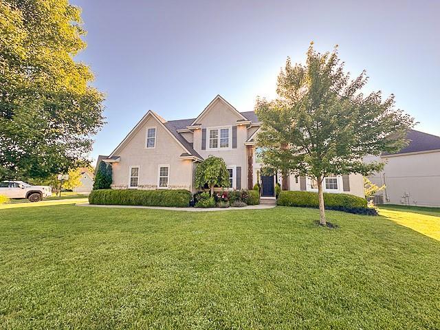 1101 SW Sunflower Dr, Lees Summit, MO 64081 - view of front facade with a front lawn and stucco siding