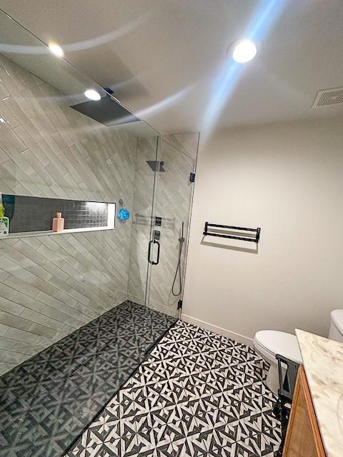 1101 SW Sunflower Dr, Lees Summit, MO 64081 - full bathroom featuring toilet, a shower stall, vanity, and baseboards