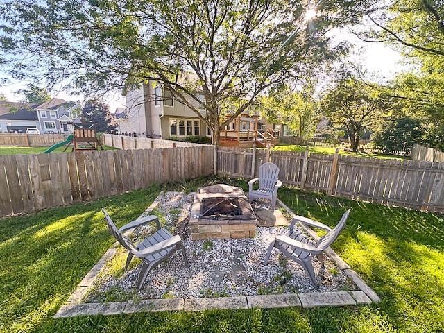 1101 SW Sunflower Dr, Lees Summit, MO 64081 - view of yard featuring a fire pit, a playground, and a residential view