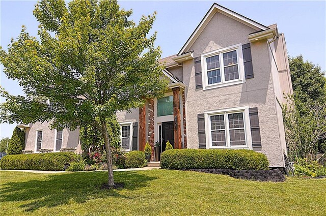 1101 SW Sunflower Dr, Lees Summit, MO 64081 - view of front of home with a front yard and stucco siding