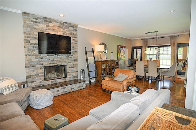 1101 SW Sunflower Dr, Lees Summit, MO 64081 - living area featuring crown molding, wood finished floors, a stone fireplace, and recessed lighting
