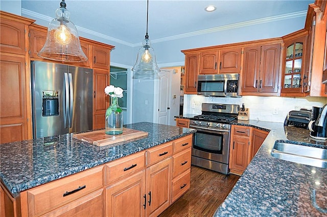 1101 SW Sunflower Dr, Lees Summit, MO 64081 - kitchen with stainless steel appliances, ornamental molding, a kitchen island, glass insert cabinets, and decorative backsplash