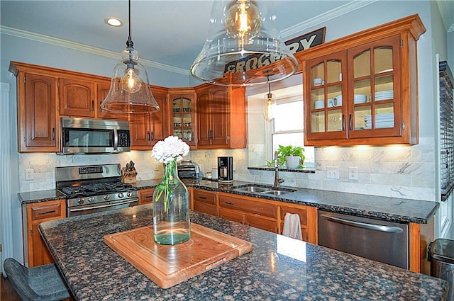 1101 SW Sunflower Dr, Lees Summit, MO 64081 - kitchen with stainless steel appliances, brown cabinets, glass insert cabinets, hanging light fixtures, and a sink