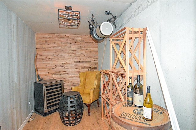 1101 SW Sunflower Dr, Lees Summit, MO 64081 - sitting room featuring wood finished floors, wood walls, and beverage cooler