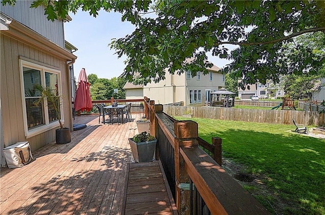 1101 SW Sunflower Dr, Lees Summit, MO 64081 - deck with outdoor dining space and a playground