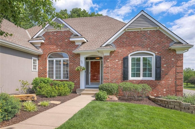 7904 W 153rd Ter, Overland Park, KS 66223 - traditional-style house with brick siding, a front yard, and roof with shingles