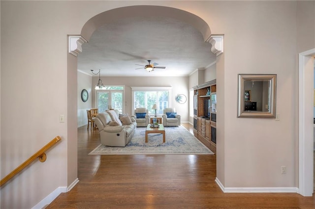 7904 W 153rd Ter, Overland Park, KS 66223 - living room with a fireplace, arched walkways, a ceiling fan, wood finished floors, and ornamental molding