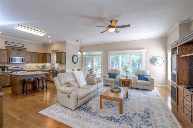 7904 W 153rd Ter, Overland Park, KS 66223 - living room featuring crown molding, wood finished floors, and a ceiling fan