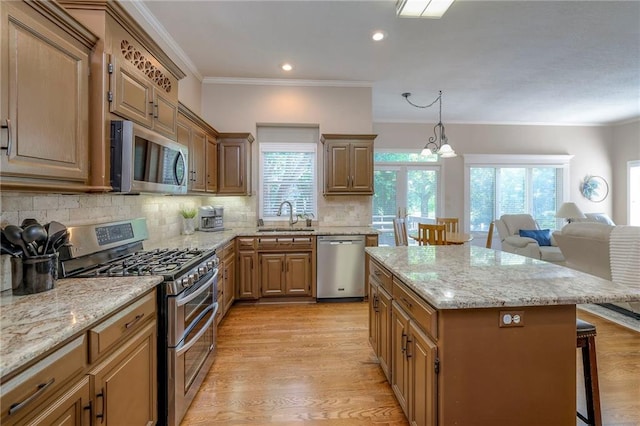 7904 W 153rd Ter, Overland Park, KS 66223 - kitchen with stainless steel appliances, a kitchen breakfast bar, crown molding, tasteful backsplash, and light stone counters