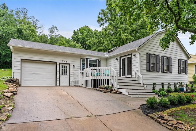 44 G St, Lake Lotawana, MO 64086 - single story home with an attached garage, driveway, a deck, and roof with shingles