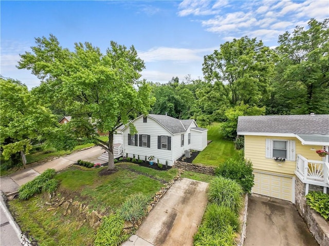44 G St, Lake Lotawana, MO 64086 - view of front of property with driveway, an attached garage, and a front lawn