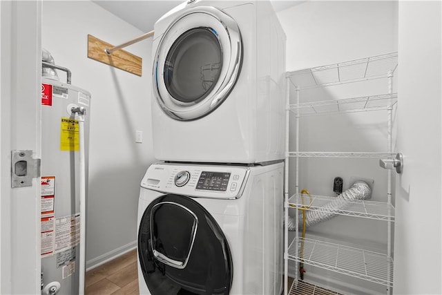 44 G St, Lake Lotawana, MO 64086 - washroom featuring stacked washer and clothes dryer, water heater, wood finished floors, and baseboards