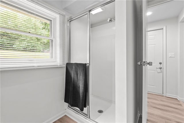 44 G St, Lake Lotawana, MO 64086 - full bathroom featuring a shower stall, wood finished floors, and baseboards