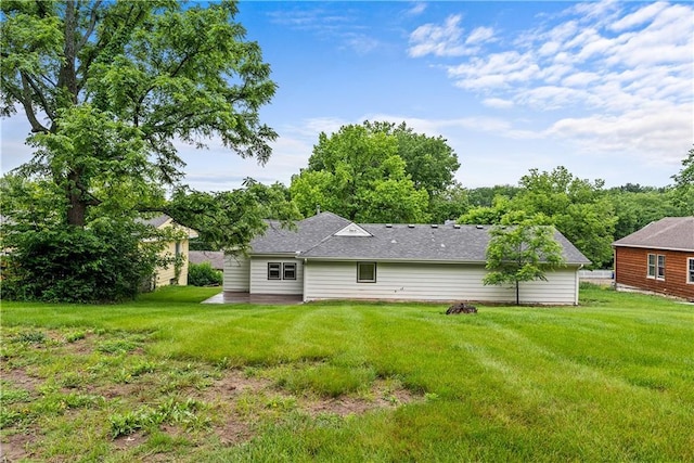 44 G St, Lake Lotawana, MO 64086 - back of house featuring a yard and roof with shingles