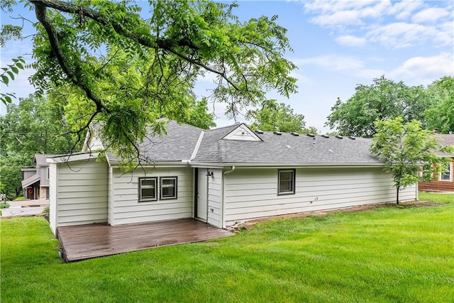 44 G St, Lake Lotawana, MO 64086 - back of house featuring roof with shingles, a lawn, and a deck
