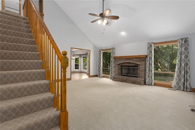 2432 SE 6th St, Lees Summit, MO 64063 - unfurnished living room with carpet floors, stairs, high vaulted ceiling, a ceiling fan, and a fireplace