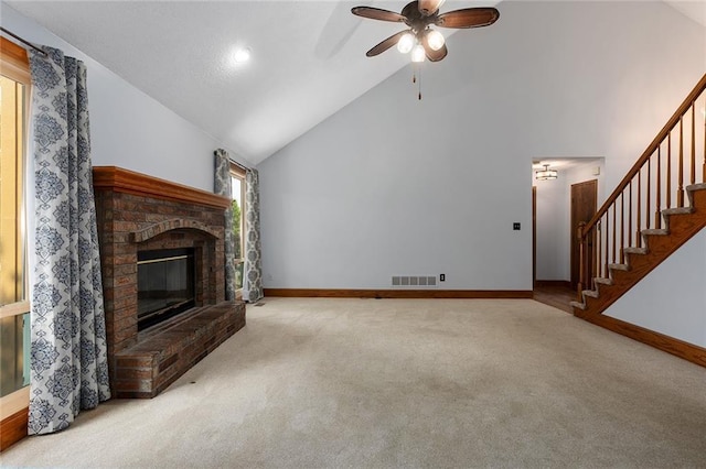 2432 SE 6th St, Lees Summit, MO 64063 - unfurnished living room featuring carpet floors, high vaulted ceiling, a fireplace, ceiling fan, and stairs