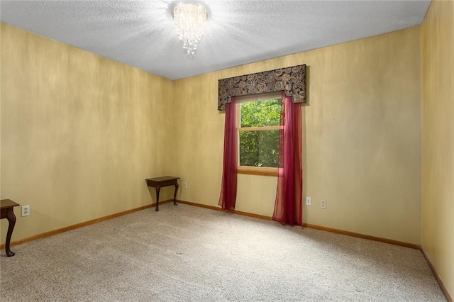 2432 SE 6th St, Lees Summit, MO 64063 - empty room with carpet flooring, a textured ceiling, and a chandelier