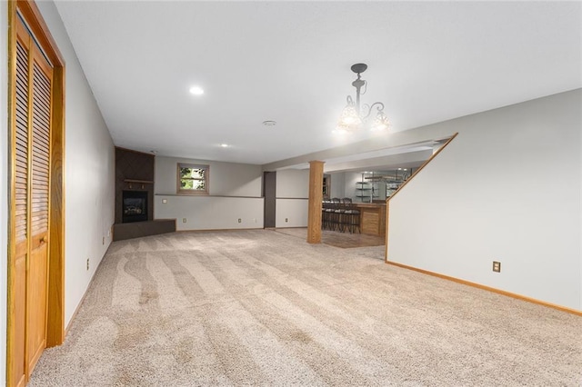 2432 SE 6th St, Lees Summit, MO 64063 - unfurnished living room featuring carpet flooring, a large fireplace, recessed lighting, stairs, and bar area