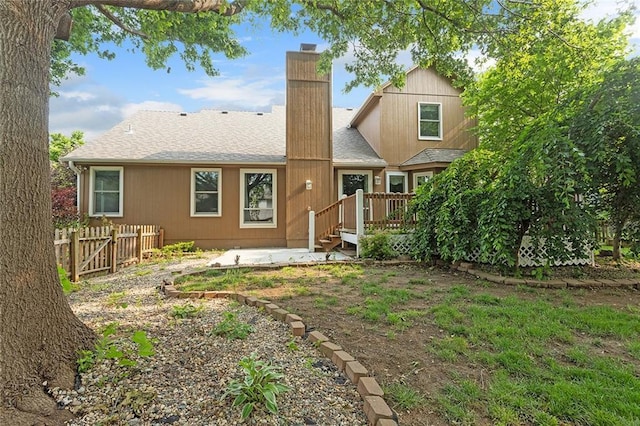 2432 SE 6th St, Lees Summit, MO 64063 - rear view of house with a chimney, a patio, roof with shingles, and a deck