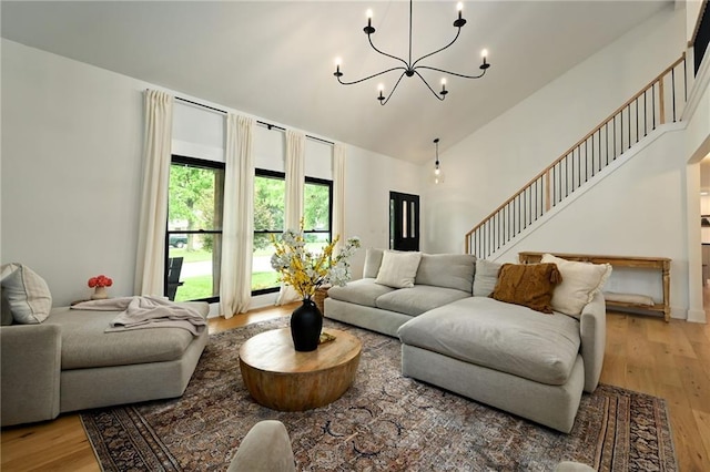 110 Cherokee Ln, Lake Winnebago, MO 64034 - living area featuring light wood-style flooring, a chandelier, stairway, and high vaulted ceiling