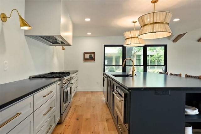 110 Cherokee Ln, Lake Winnebago, MO 64034 - kitchen featuring custom exhaust hood, a sink, range with two ovens, light wood-style floors, and a kitchen island with sink