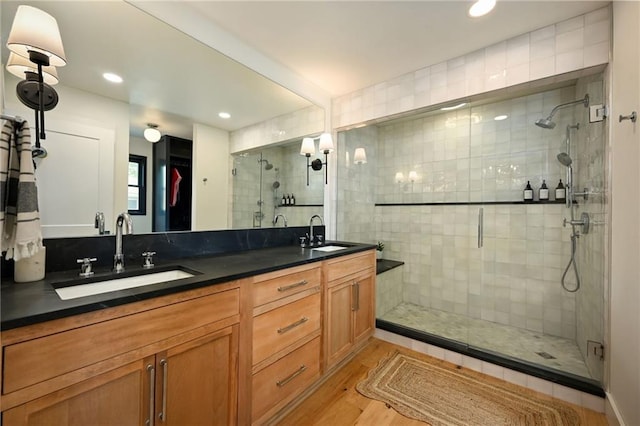 110 Cherokee Ln, Lake Winnebago, MO 64034 - bathroom with a shower stall, double vanity, a walk in closet, wood finished floors, and recessed lighting