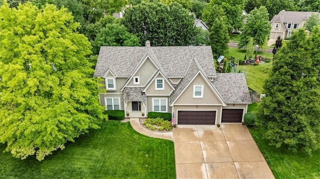 12806 Goddard Ave, Overland Park, KS 66213 - craftsman-style home with a front yard, driveway, a chimney, and stucco siding