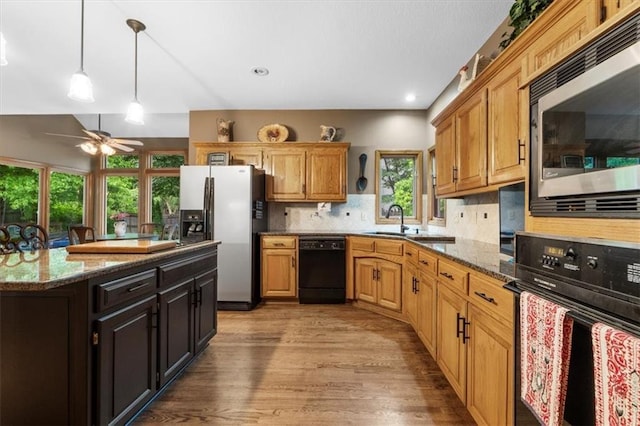 12806 Goddard Ave, Overland Park, KS 66213 - kitchen with wall oven, fridge with ice dispenser, stainless steel microwave, dishwasher, and a sink