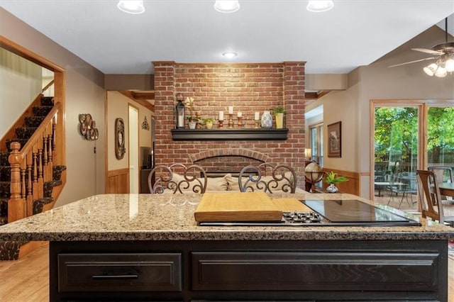 12806 Goddard Ave, Overland Park, KS 66213 - kitchen with a ceiling fan, light stone countertops, light wood finished floors, and dark brown cabinetry