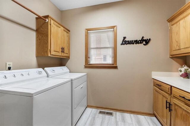 12806 Goddard Ave, Overland Park, KS 66213 - laundry room with cabinet space, washing machine and clothes dryer, and baseboards