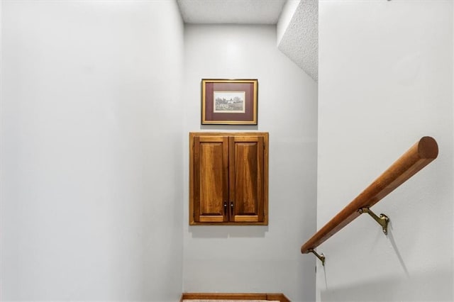 12806 Goddard Ave, Overland Park, KS 66213 - stairway with a textured ceiling and baseboards