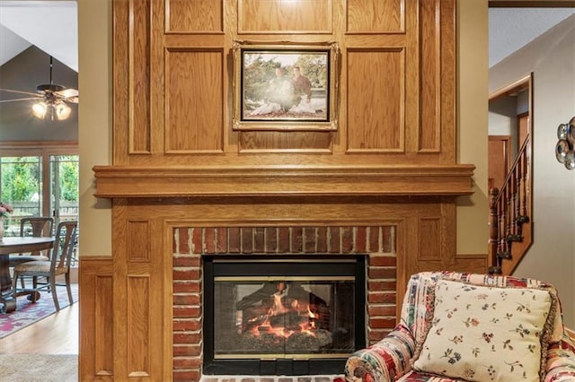 12806 Goddard Ave, Overland Park, KS 66213 - detailed view of a fireplace, ceiling fan, and wood finished floors