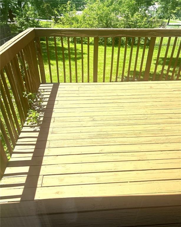10636 N Grand Ave, Kansas City, MO 64155 - wooden terrace with a lawn